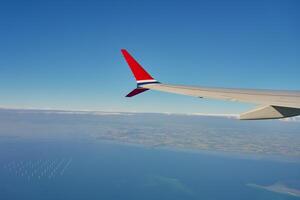 View of airplane wing from an airplane window photo