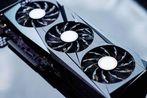 High-end graphics card with triple fan cooling on dark background photo