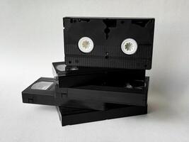 Stack of vintage vhs tapes on a white background highlighting retro media photo