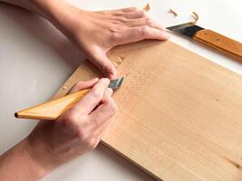 Woodworking craftsmanship. Precision carving techniques on wooden surface photo