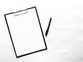 Minimalist clipboard with blank paper and pen on white background photo