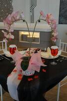 Holidays romantic, dinner table and setting for valentines day, fine dining or date at indoor night restaurant. Interior diner for evening couple reservation photo