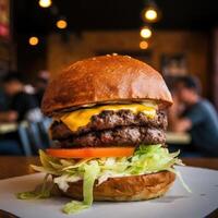 A large hamburger with cheese and lettuce on a table photo
