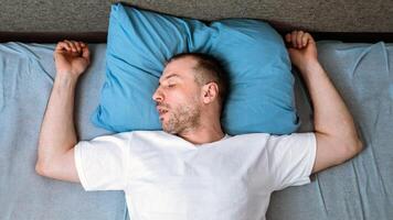 Man Sleeping Alone And Snoring Lying In Bed Staying At Home During Social Distancing Quarantine. Above View photo