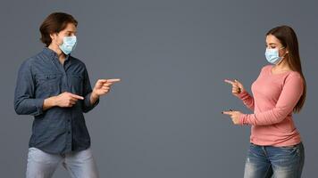 Current Information About COVID-19. Man And Woman In Medical Masks Pointing At Copy Space In The Middle Of Background, Panorama photo