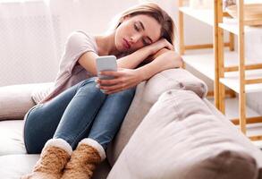 Girl stayed at home in isolation and typing on smartphone photo