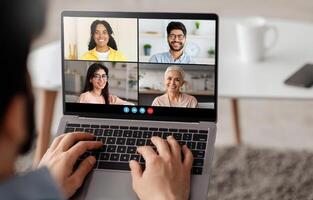 A person engages in a call with four individuals, sharing ideas and collaborating digitally. This scene reflects modern remote communication and teamwork. photo