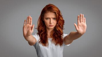 Girl Gesturing Stop With Both Hands Frowning Looking At Camera Posing On Gray Studio Background. No Bullying Concept. Panorama photo
