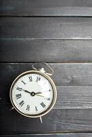alarm clock on a wooden table photo