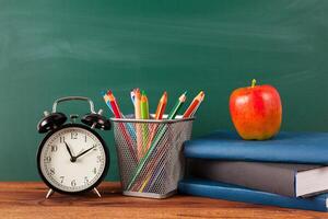 back to school - apple and books with pencils and blackboard photo