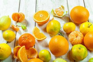 Citrus fresh fruit on the white wooden table photo