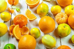 Citrus fresh fruit on the white wooden table photo