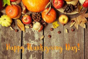 Happy thanksgiving day display on wooden background photo