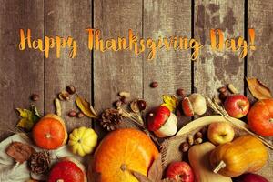 Happy thanksgiving day display on wooden background photo