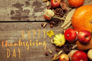 Happy thanksgiving day display on wooden background photo
