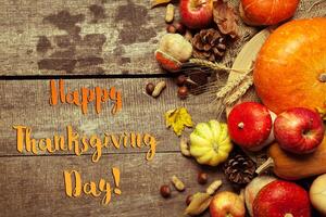 Happy thanksgiving day display on wooden background photo