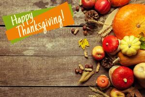 Happy thanksgiving day display on wooden background photo