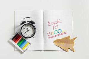 text back to school with open page notebook photo