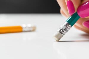side view of hand with rubber eraser photo