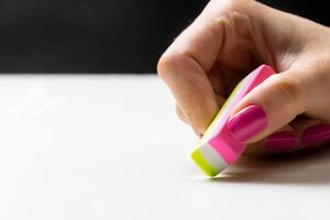 side view of hand with rubber eraser photo