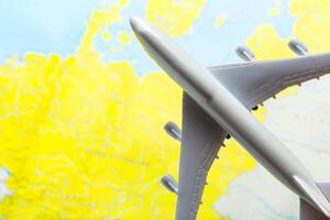 miniature of a passenger aircraft flying on a map photo