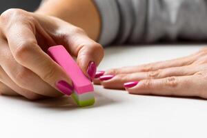 side view of hand with rubber eraser photo
