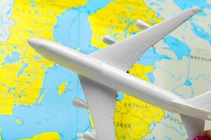 miniature of a passenger aircraft flying on a map photo