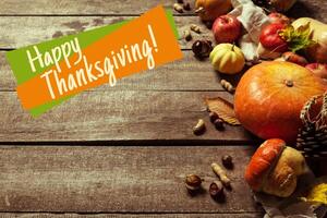 Happy thanksgiving day display on wooden background photo