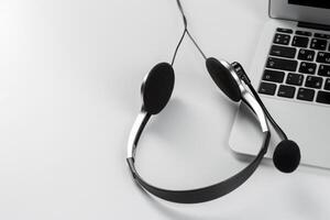 call center support concept. headset on keyboard computer laptop photo