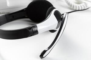 call center support concept. headset on keyboard computer laptop photo