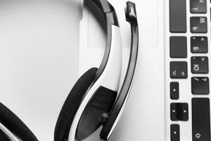 call center support concept. headset on keyboard computer laptop photo
