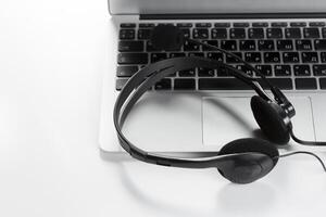call center support concept. headset on keyboard computer laptop photo