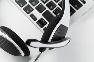 call center support concept. headset on keyboard computer laptop photo