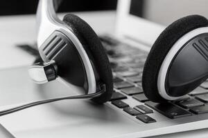 call center support concept. headset on keyboard computer laptop photo