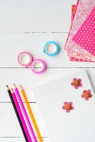 Crafting a colorful workspace with decorations, stationery, and artistic tools on a clean wooden surface photo