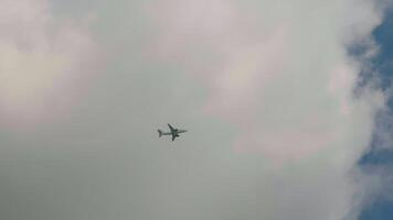 Cloudy sky and high-rising plane flying away as seen from below. video