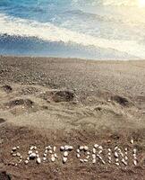 Text Santorini made with pumice stones photo