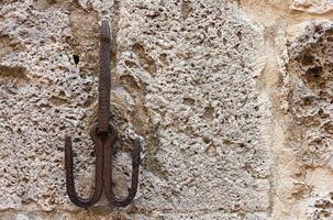 Wrought iron hook of medieval origin in the center of San Gimignano, a small medieval village of Tuscany in the province of Siena. photo