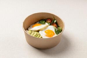 Fried eggs with avocado sandwich and salad with cherry tomatoes photo