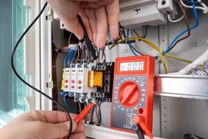 Technician Holding Probes for Circuit Testing with Multimeter photo