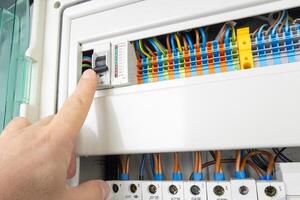 Hand Operating Electrical Circuit Breaker in Control Panel photo
