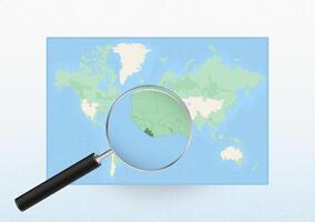 Map of the World with a magnifying glass aimed at Liberia, searching Liberia with loupe. vector