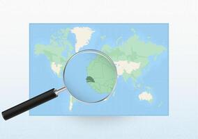 Map of the World with a magnifying glass aimed at Senegal, searching Senegal with loupe. vector