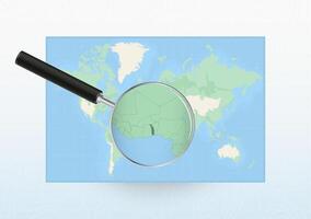 Map of the World with a magnifying glass aimed at Togo, searching Togo with loupe. vector