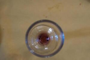 glass wine glass seen from above with a residual bottom of red wine in an Italian bar photo