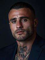 A close-up portrait of a man with tattoos and sharp features indoors photo
