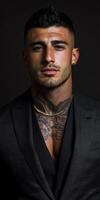 Stylish man with tattoos poses confidently in dark attire photo