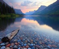Sunset over tranquil lake with colorful stones and distant mountains photo