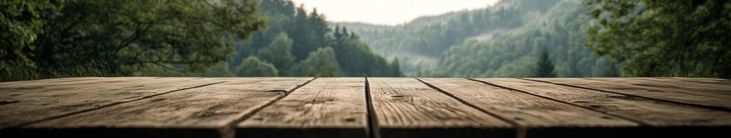 Serene forest landscape viewed from a rustic wooden table at sunrise photo