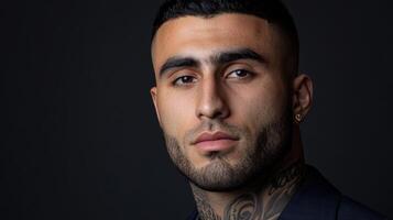 Tattooed man in stylish attire, dynamic pose, dark background photo
